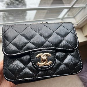 A black mini bag with gold details